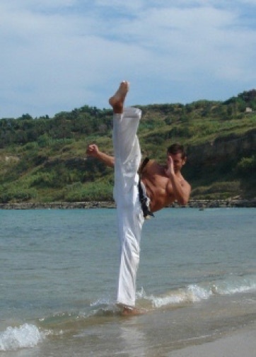 Shihan Roberto Di Blasio demonstratin Mawashi geri. at the beach.