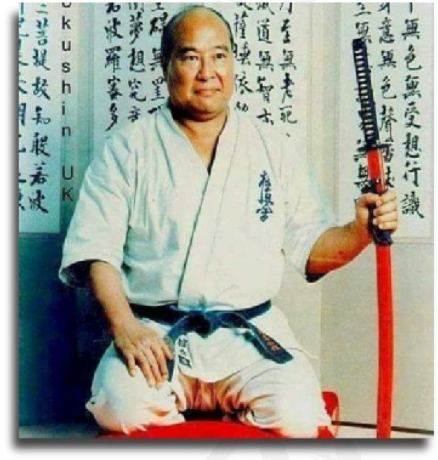 Portret of Sosai Masutatsu Oyama sitting with sword.